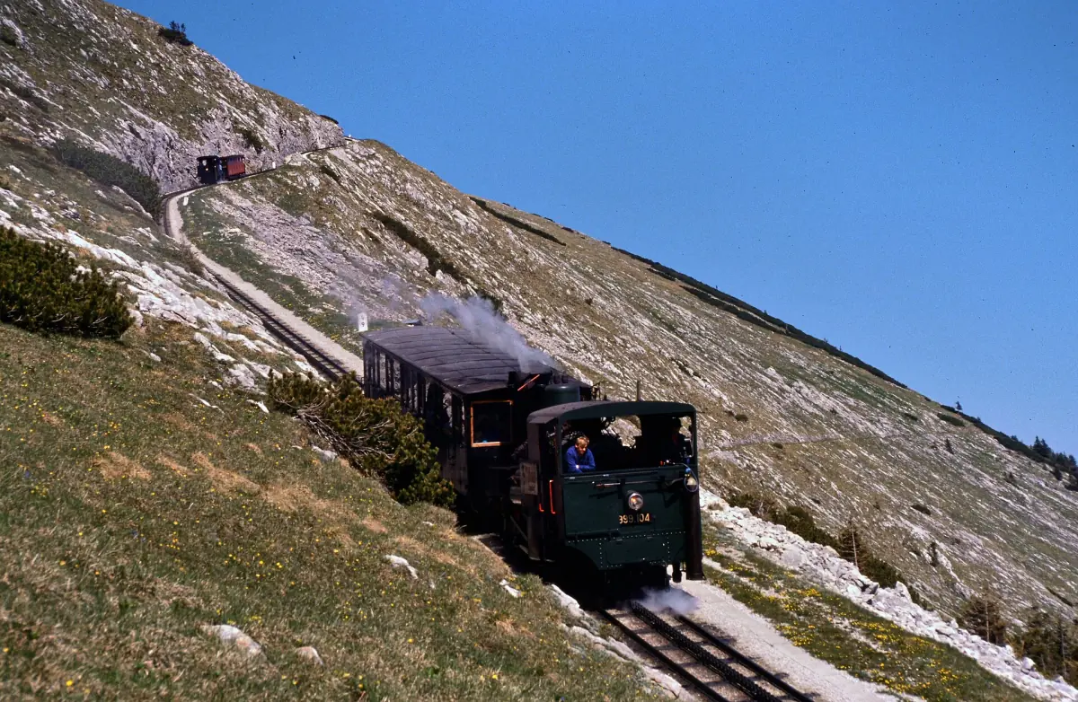 A steam train of the Schafberg cog railway on the mountainside
